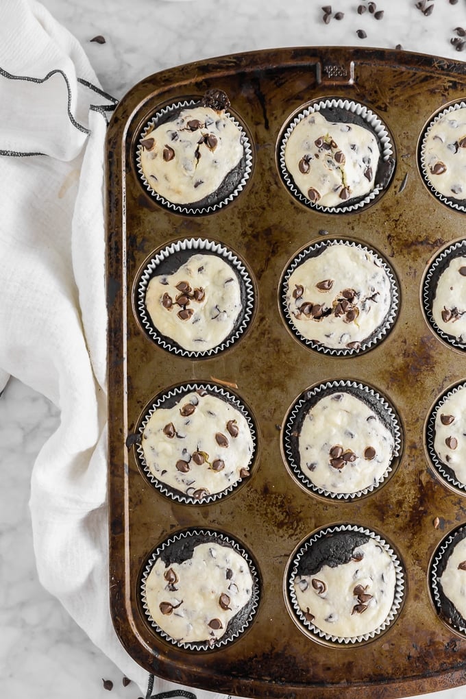A photo of a muffin tin filled with gluten-free chocolate cheesecake cupcakes