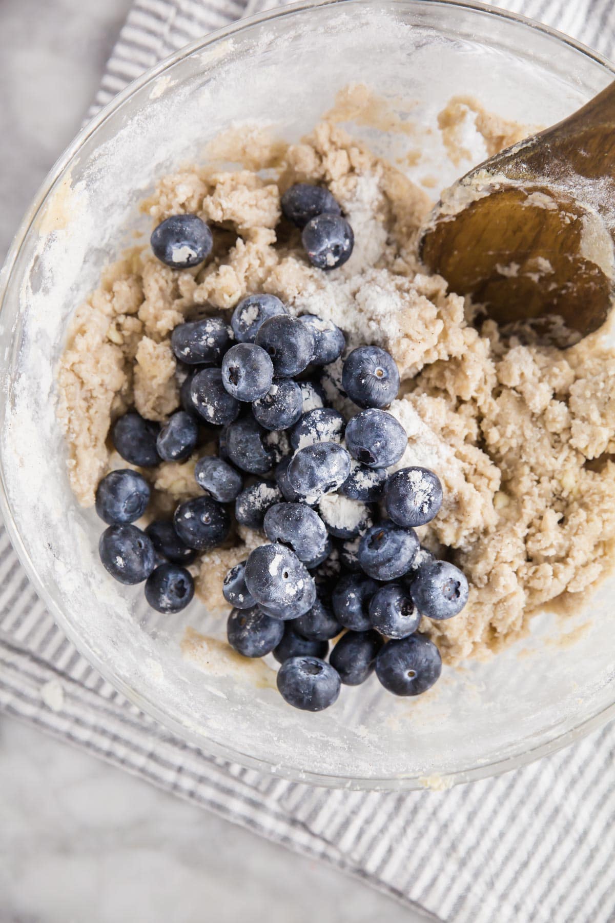 A photo of blueberries being folded into gluten-free scone dough. 