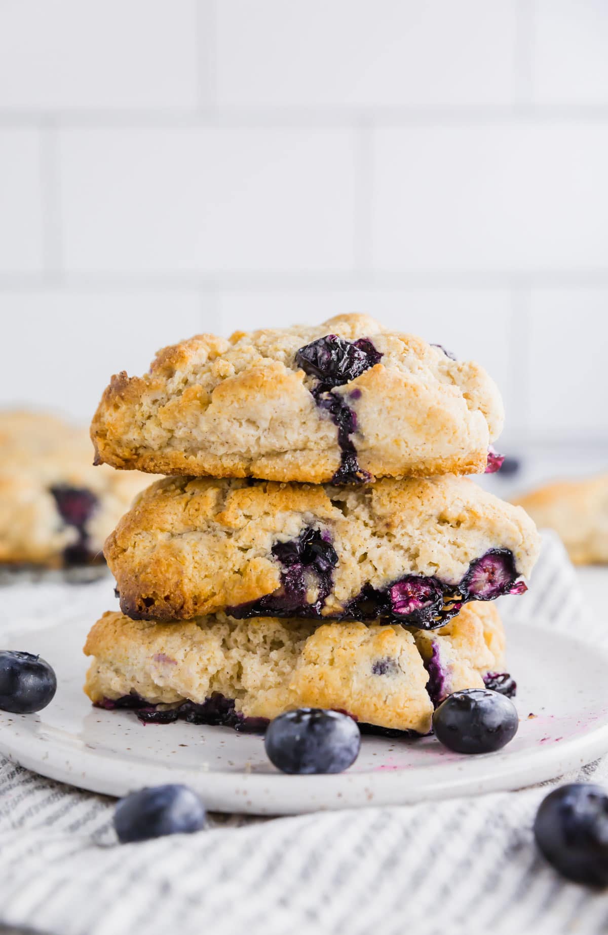 A stack of three gluten-free blueberry scones on a small plate. 