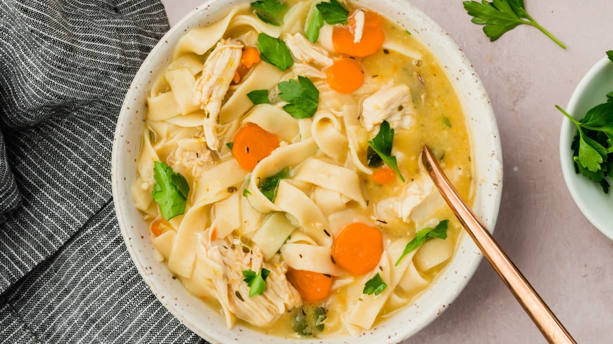 A bowl of gluten-free chicken noodle soup.