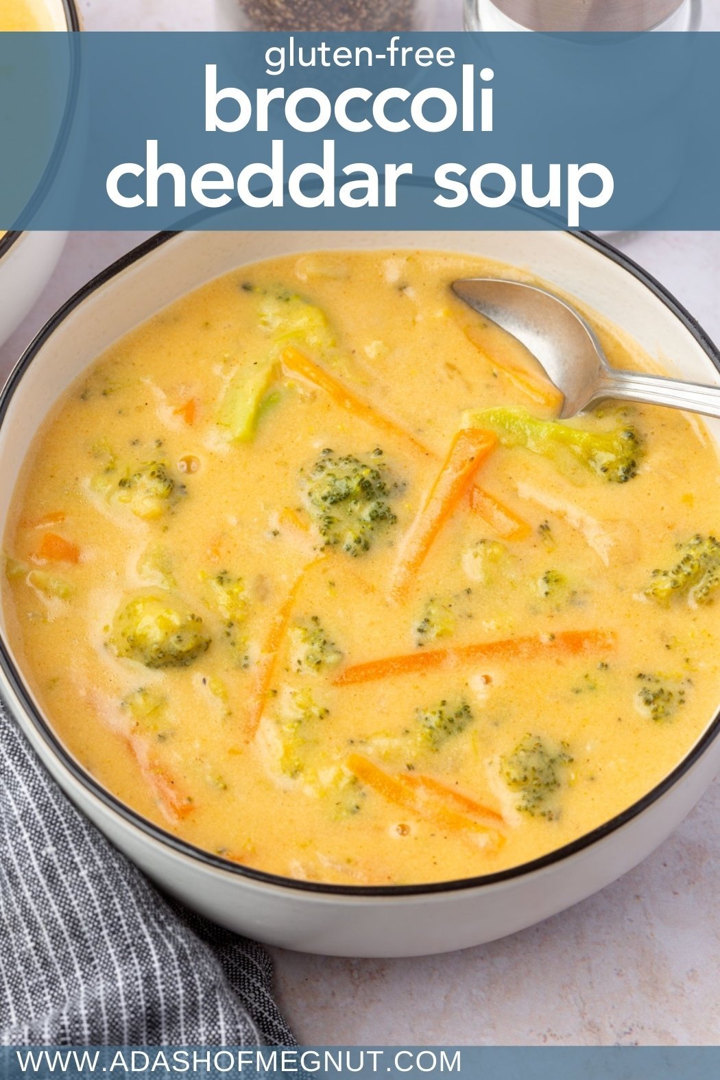 Overhead shot of a bowl of broccoli cheddar soup with carrots and broccoli in a creamy base, with text overlay reading “Gluten-Free Broccoli Cheddar Soup” and the blog’s website URL.