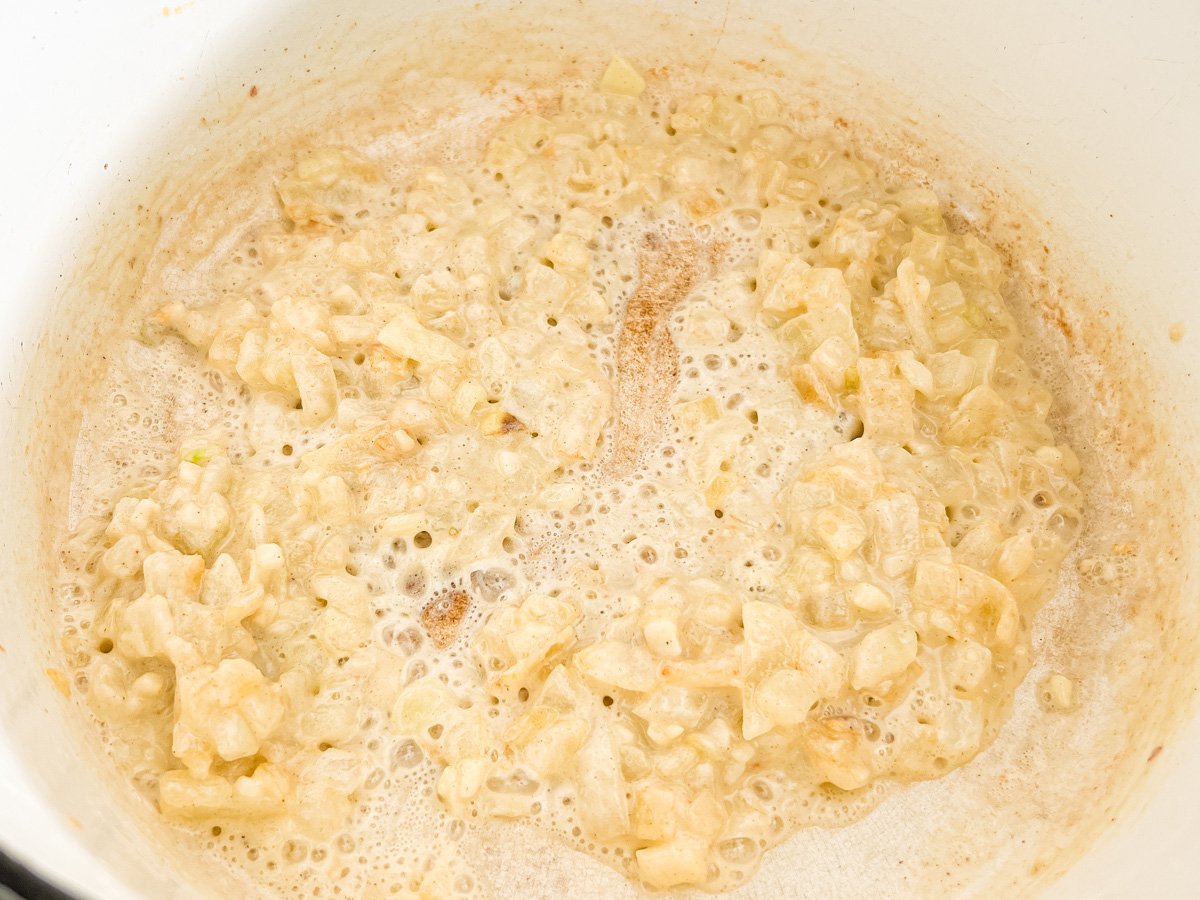 Gluten-free flour added to sautéed onions, forming the start of a roux for creamy broccoli cheddar soup.