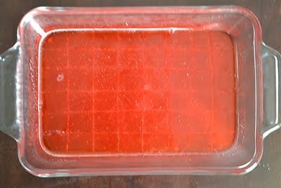 A casserole dish with red jello squares.