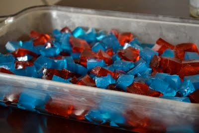 Red and blue jello cubes mixed together in a casserole dish. 