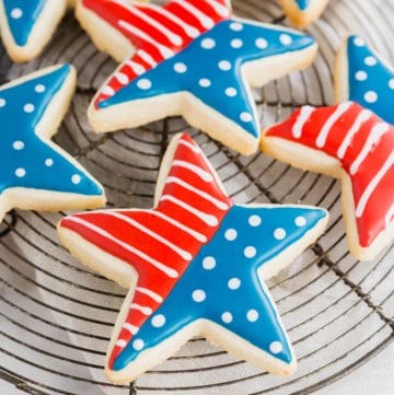 A photo of gluten-free 4th of july star sugar cookies on a cooling rack.