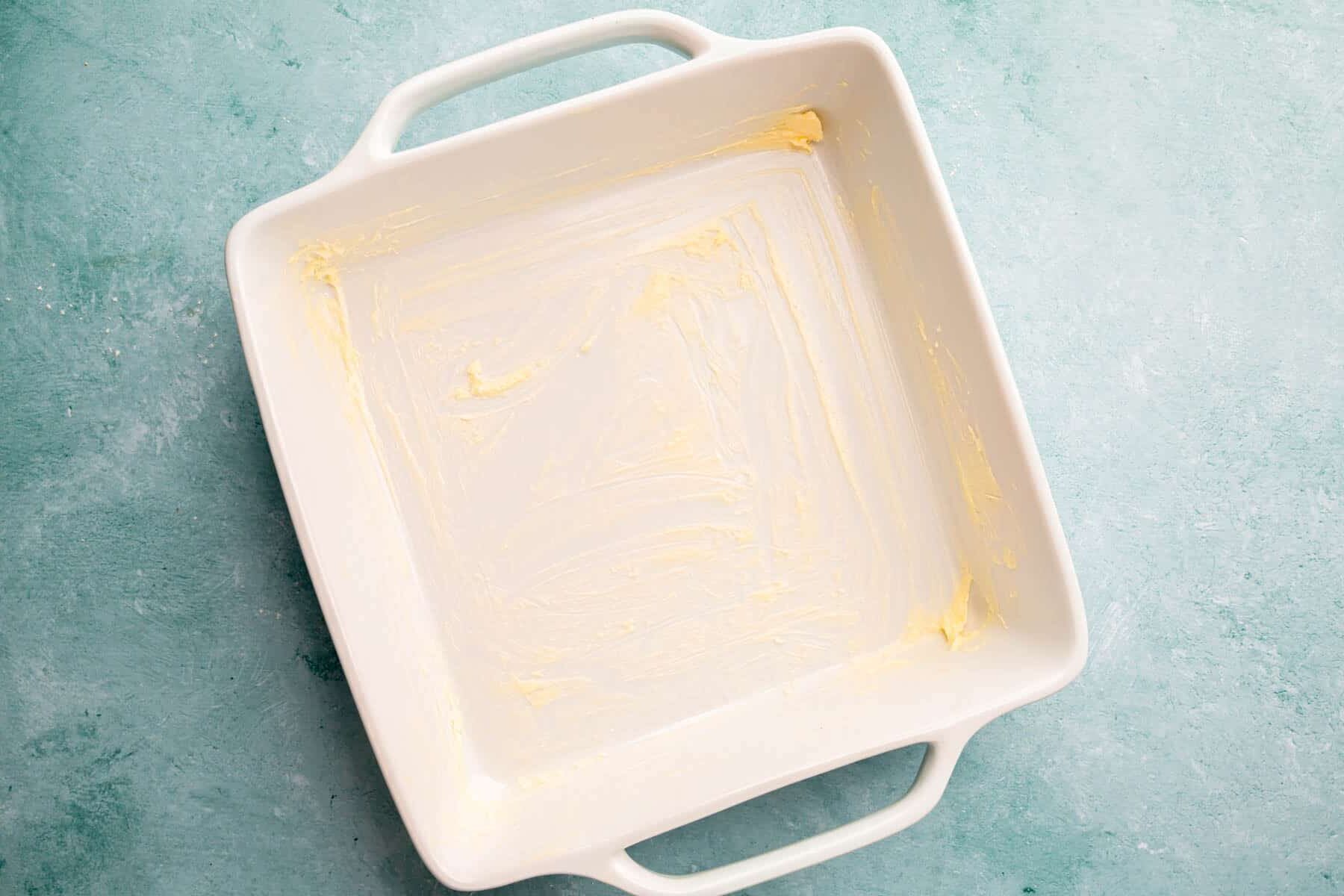 A square baking dish greased with vegan butter.