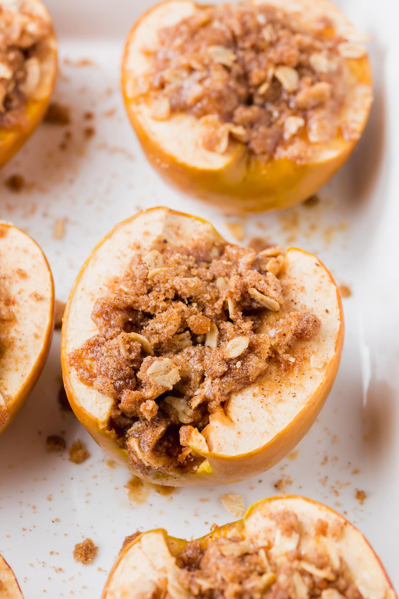 A photo of a baked apple stuffed with gluten-free streusel.