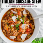 A bowl with white bean italian sausage stew with parmesan and basil on top.