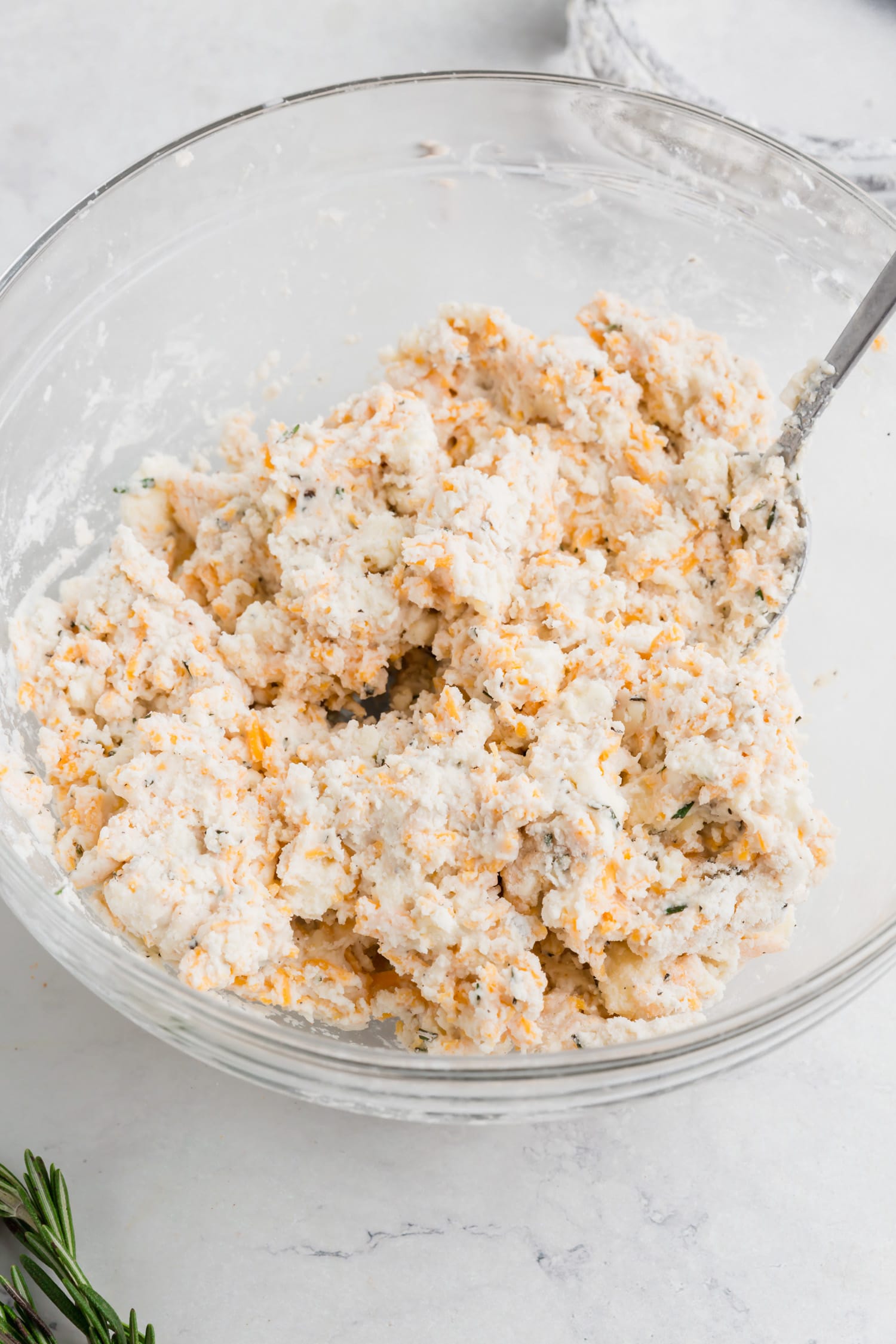 A gluten-free cheddar biscuit batter in a bowl.