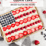 A photo of a gluten free American flag cake decorated with fresh fruit to look like the flag in a quarter sheet pan.