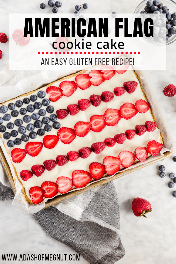 A photo of a gluten free American flag cake decorated with fresh fruit to look like the flag in a quarter sheet pan. 