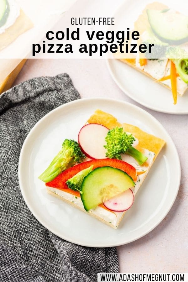 A small plate with a piece of cold veggie pizza on it with a gray napkin with a text overlay.