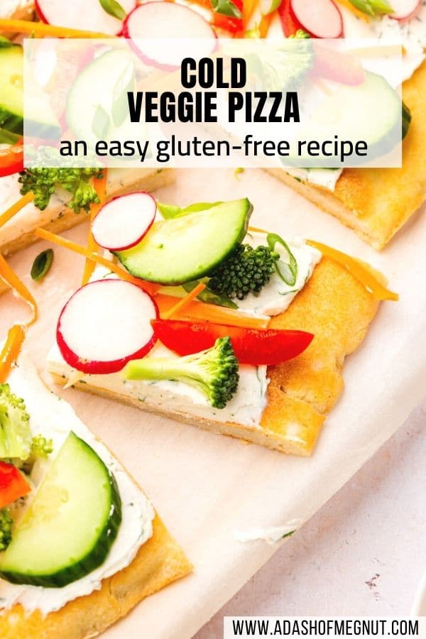 Slices of gluten-free cold veggie pizza topped with fresh vegetables on a piece of parchment paper with a text overlay.