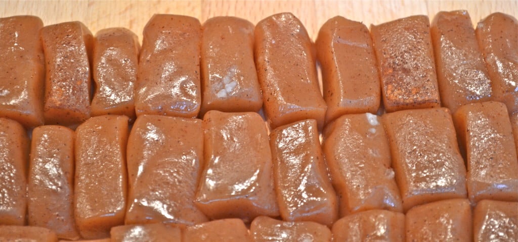 A closeup of apple cider caramels cut into rectangles.