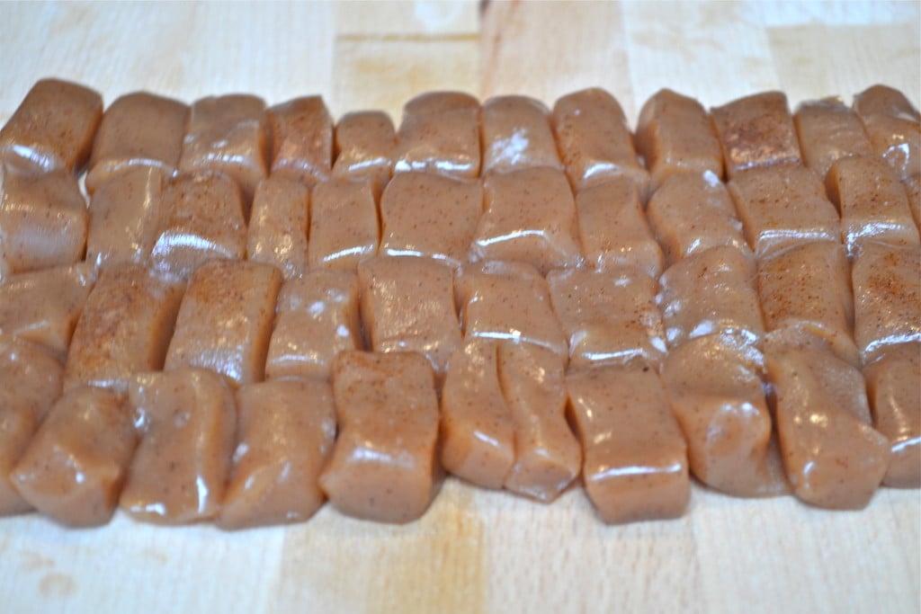 A tray of apple cider caramel cut into small rectangles.