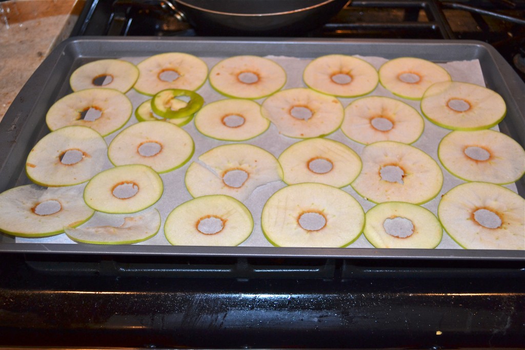 Thinly sliced apples on a baking sheet. 