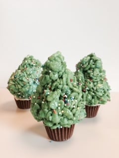 Gluten-Free Rice Krispies Treats shaped like christmas trees with a peanut butter cup tree stump.