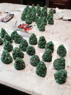 rice krispy treat trees on parchment paper.