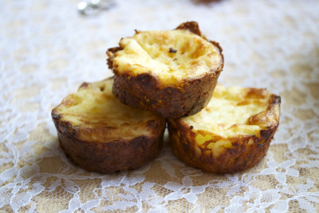 A stack of three gluten-free mini quiches on a lace tablecloth.