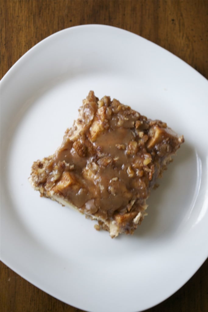 A slice of gluten-free caramel apple cheesecake bar on a white plate.