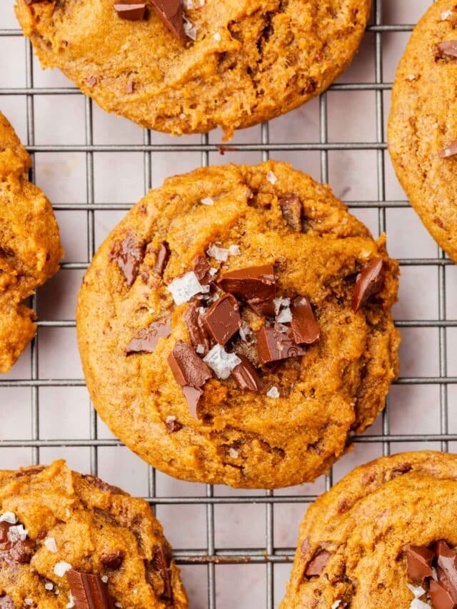 A closeup of gluten-free pumpkin chocolate chip cookies on a cooling rack.