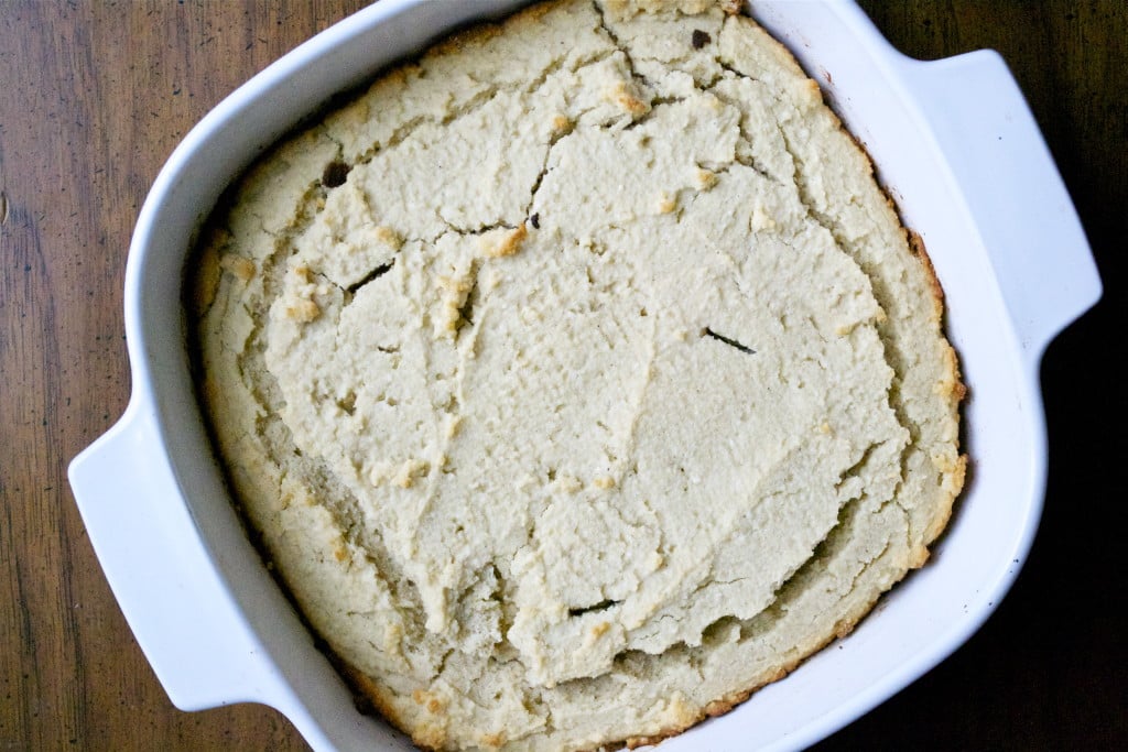 An overhead view of a casserole dish with masa harina cornbread in it.