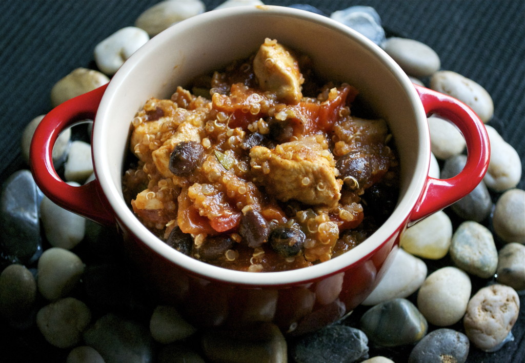 A small ramekin of chicken quinoa chili on a rock trivet.
