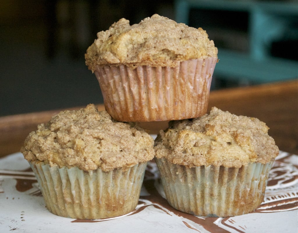 A stack of three gluten-free cinnamon streusel muffins. 