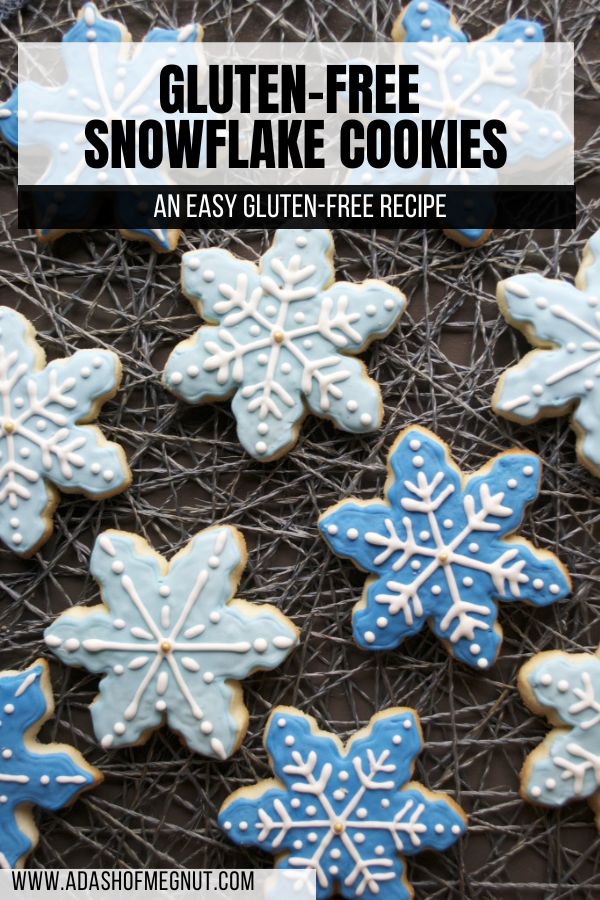Multiple snowflake sugar cookies decorated with blue and white royal icing on a webbed place mat.