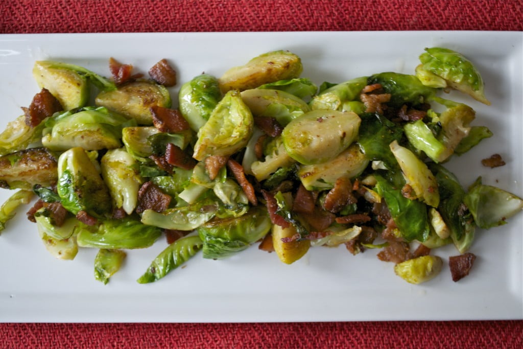 A platter of sautéed brussels sprouts and bacon. 