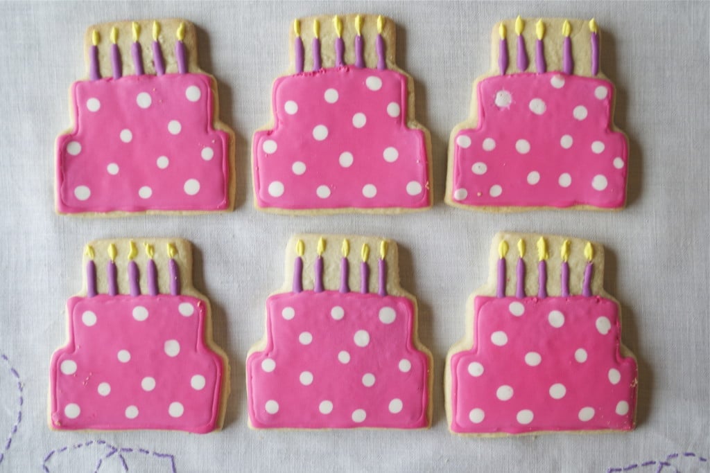 Sugar cookies decorated with royal icing to look like birthday cakes.