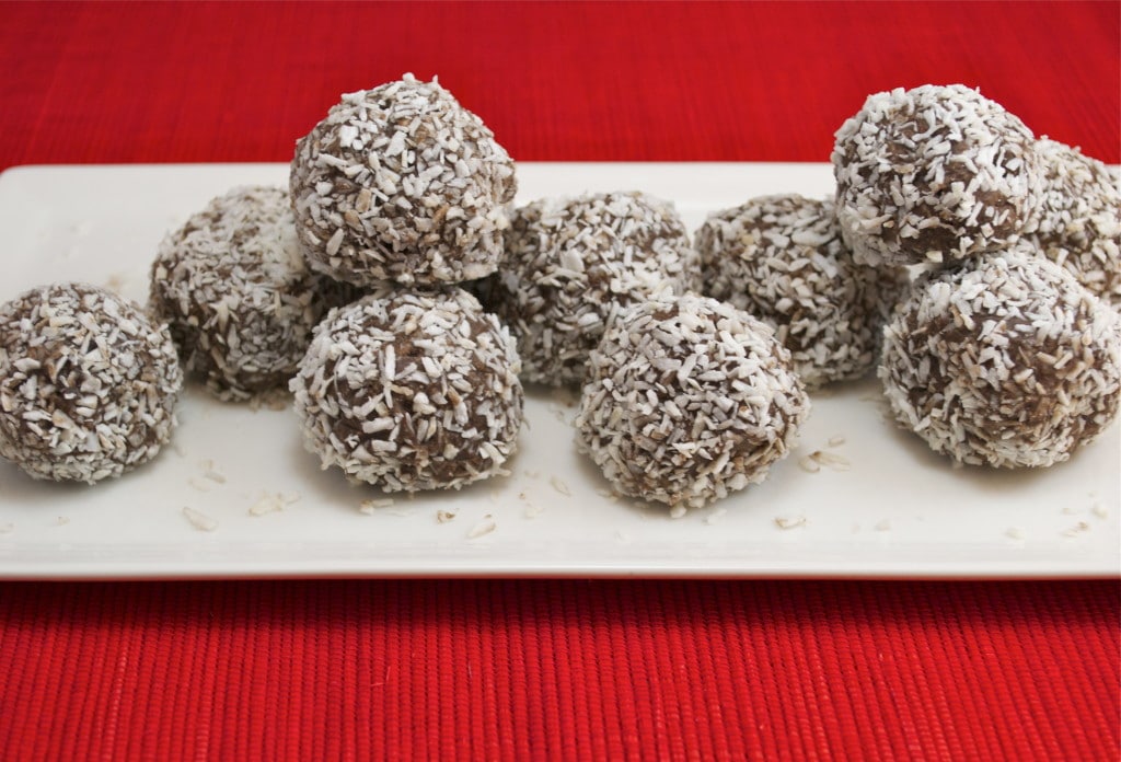 A platter of chocolate balls rolled in coconut shreds. 