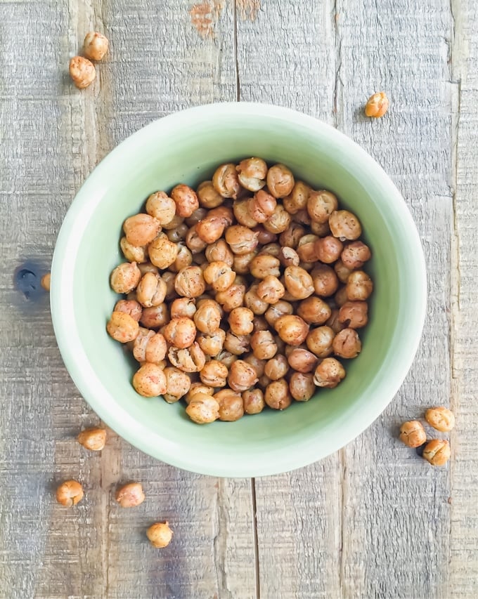 A green bowl of paprika roasted chickpeas.