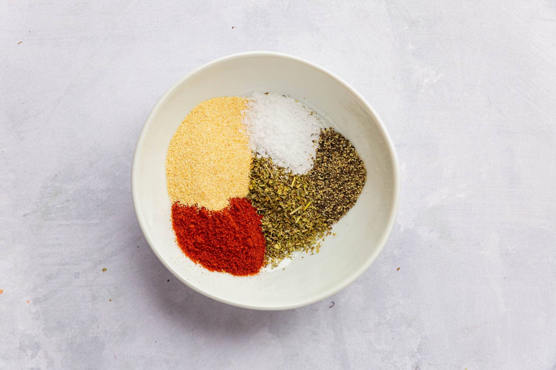 Paprika, italian seasoning, garlic powder, salt and black pepper in a small bowl.