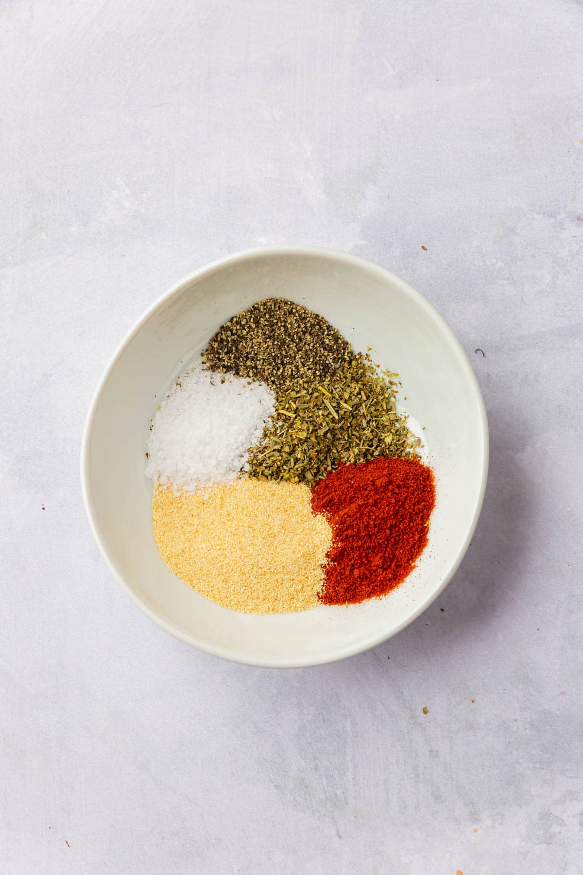 Paprika, italian seasoning, garlic powder, salt and black pepper in a small bowl.