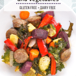 A plate of roasted sausage and colorful vegetables.