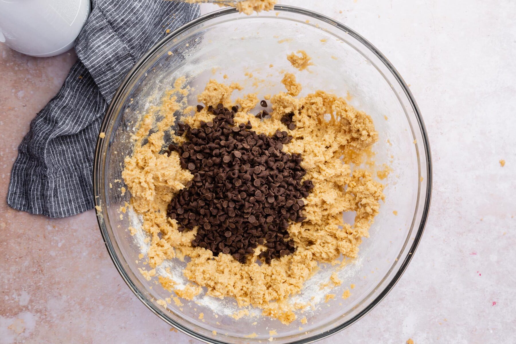 Chocolate chips in a bowl of cookie dough.
