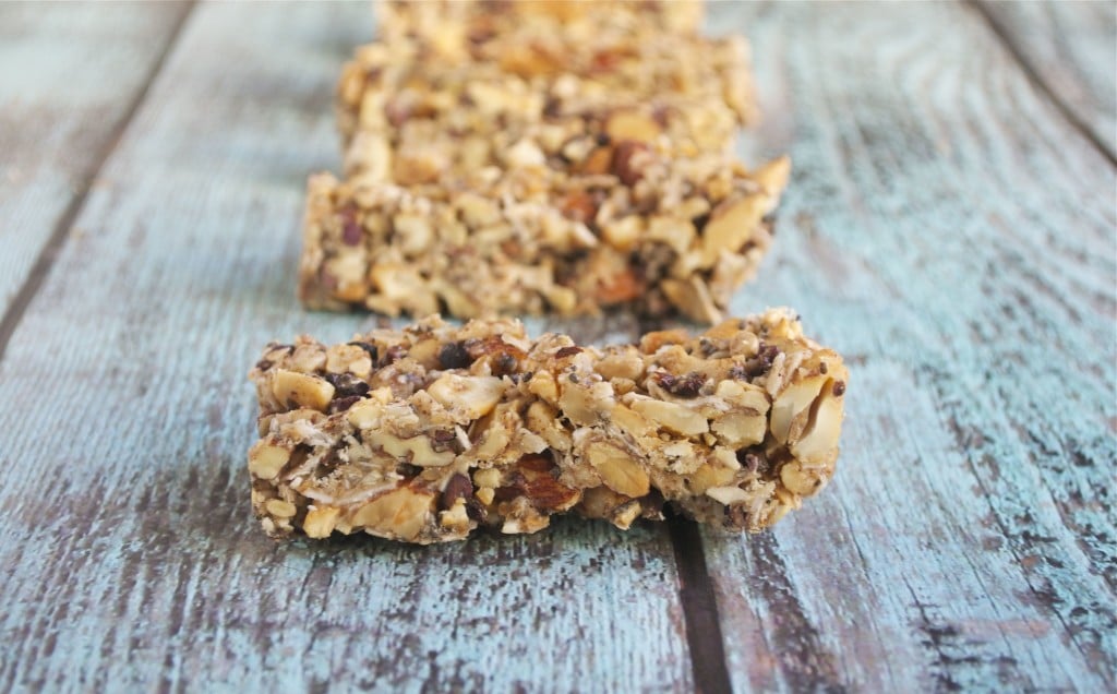 A row of grain-free granola bars on a blue wood table.