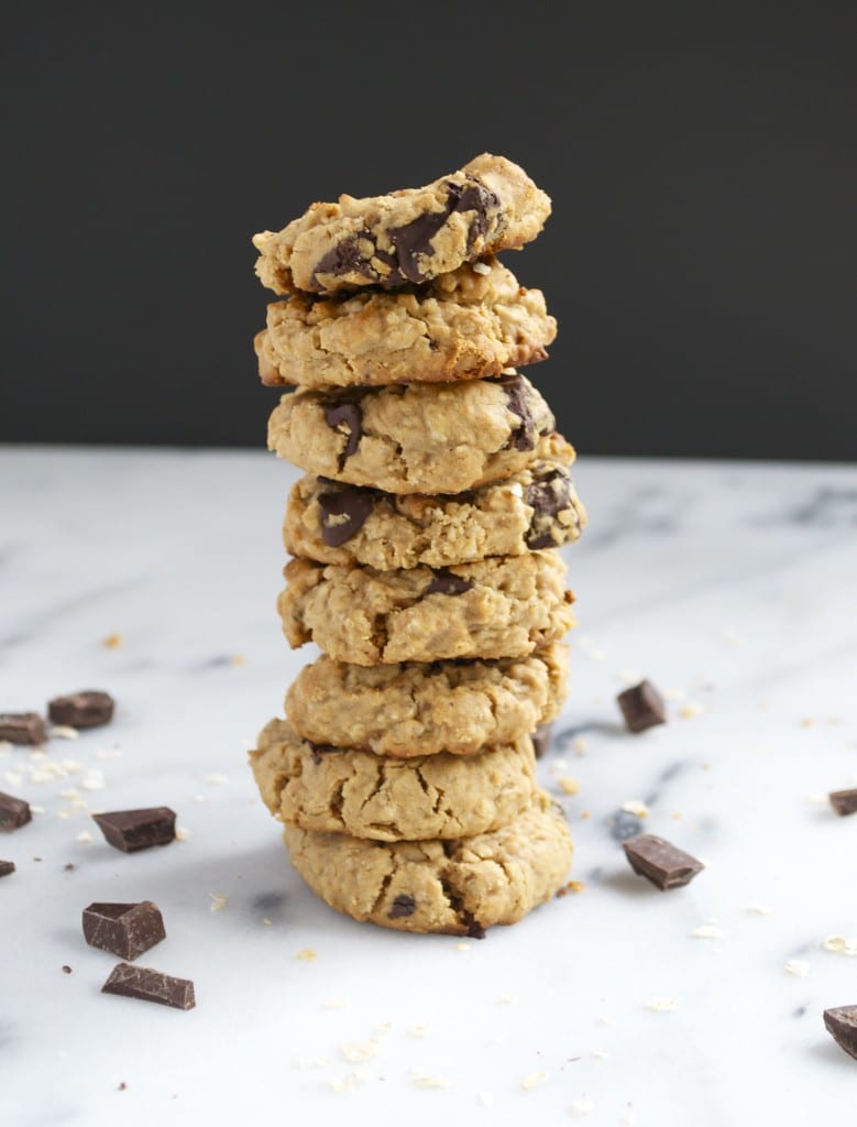 A stack of vegan peanut butter chocolate chunk cookies on a marble table. 