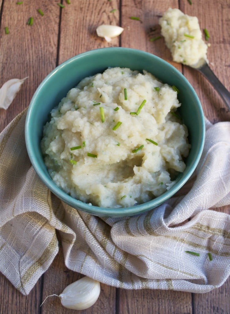 A bowl of cauliflower parsnip mash topped with scallions.