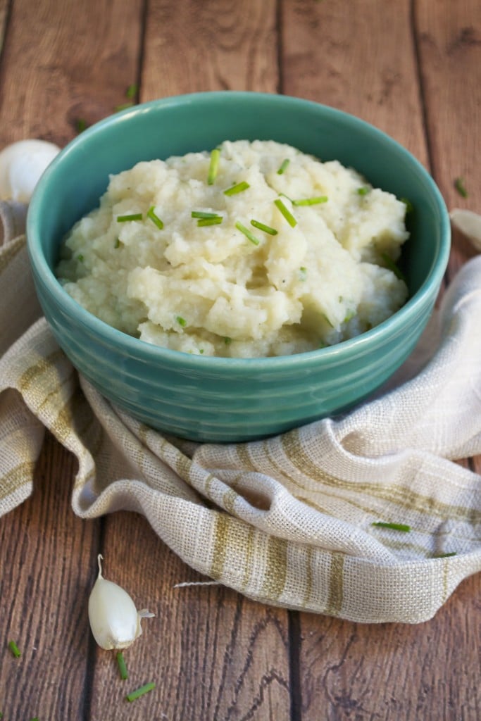 A bowl of cauliflower parsnip mash topped with scallions. 