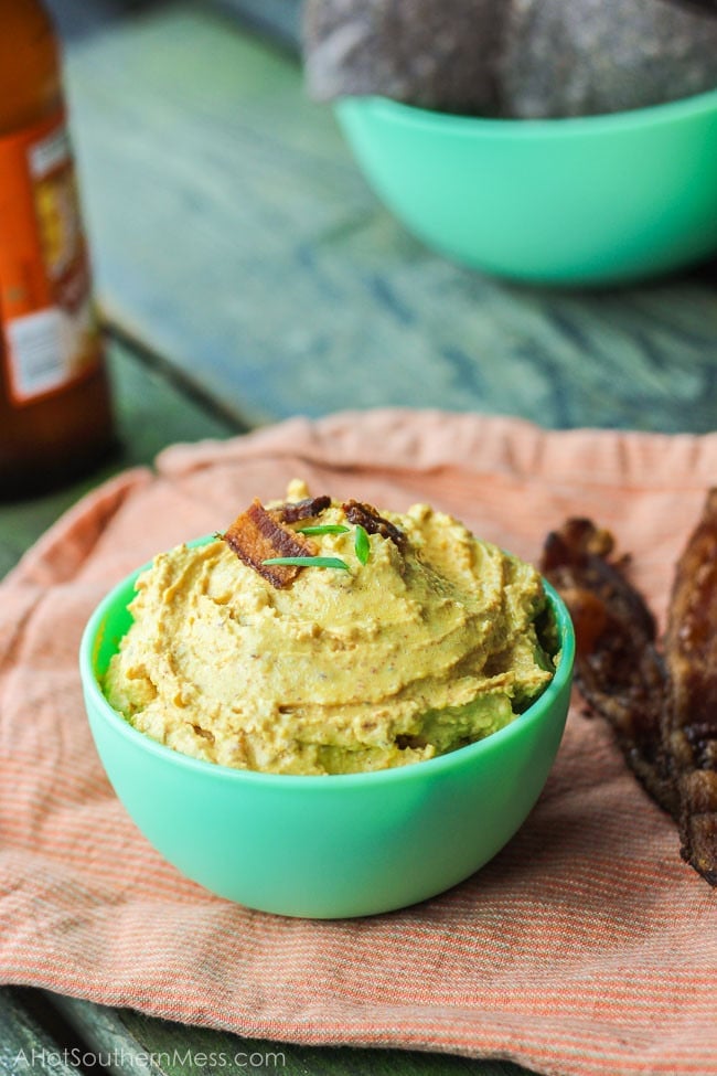 A bowl of pumpkin dip with bacon on top. 