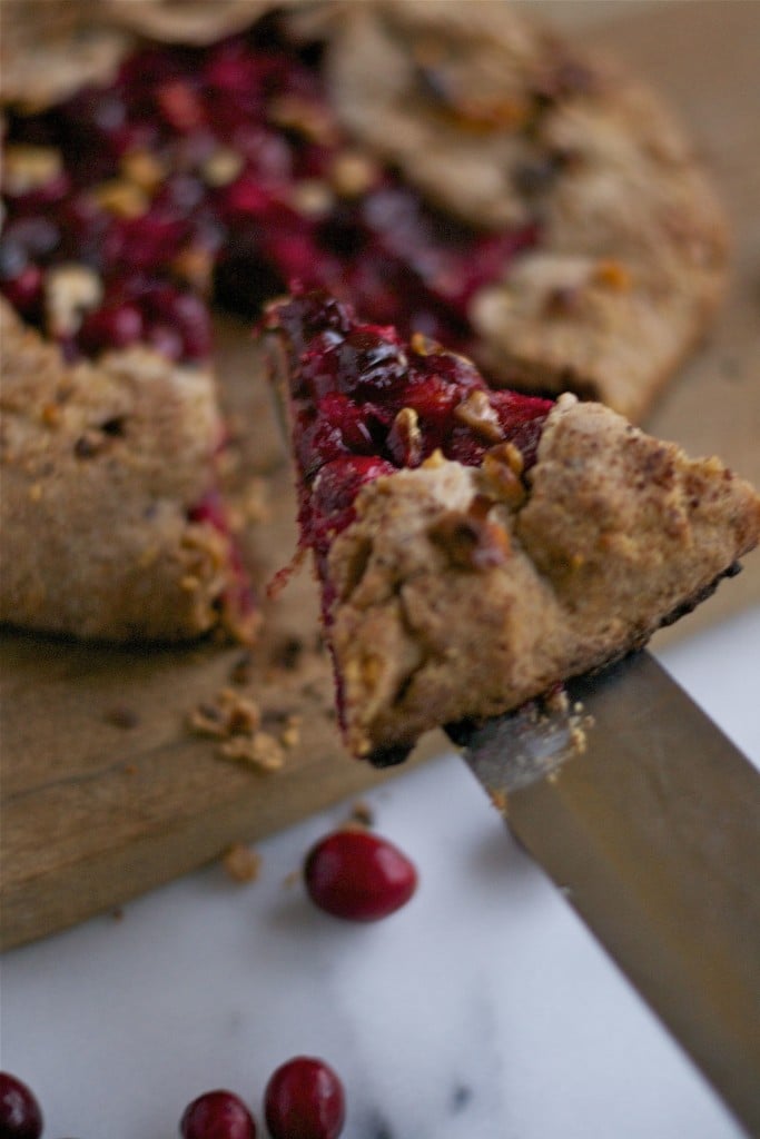A slice of cranberry galette being lifted. 