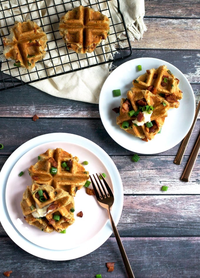 Photo shows several mashed potato waffles on plates and a cooling rack