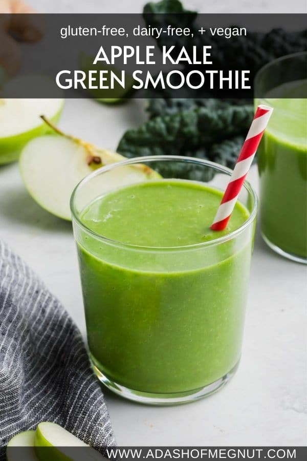 A glass of apple kale smoothie with a red striped straw.