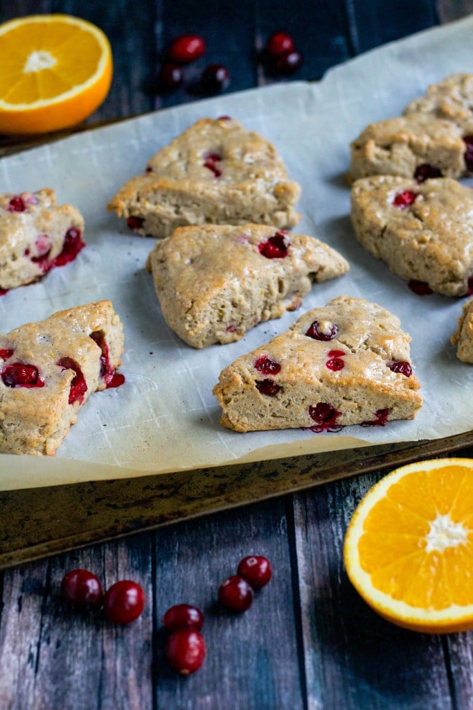 Vegan cranberry orange scones on a baking sheet lined with parchment paper