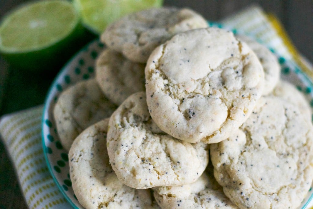 A pile of lime poppyseed cookies on a plate. 