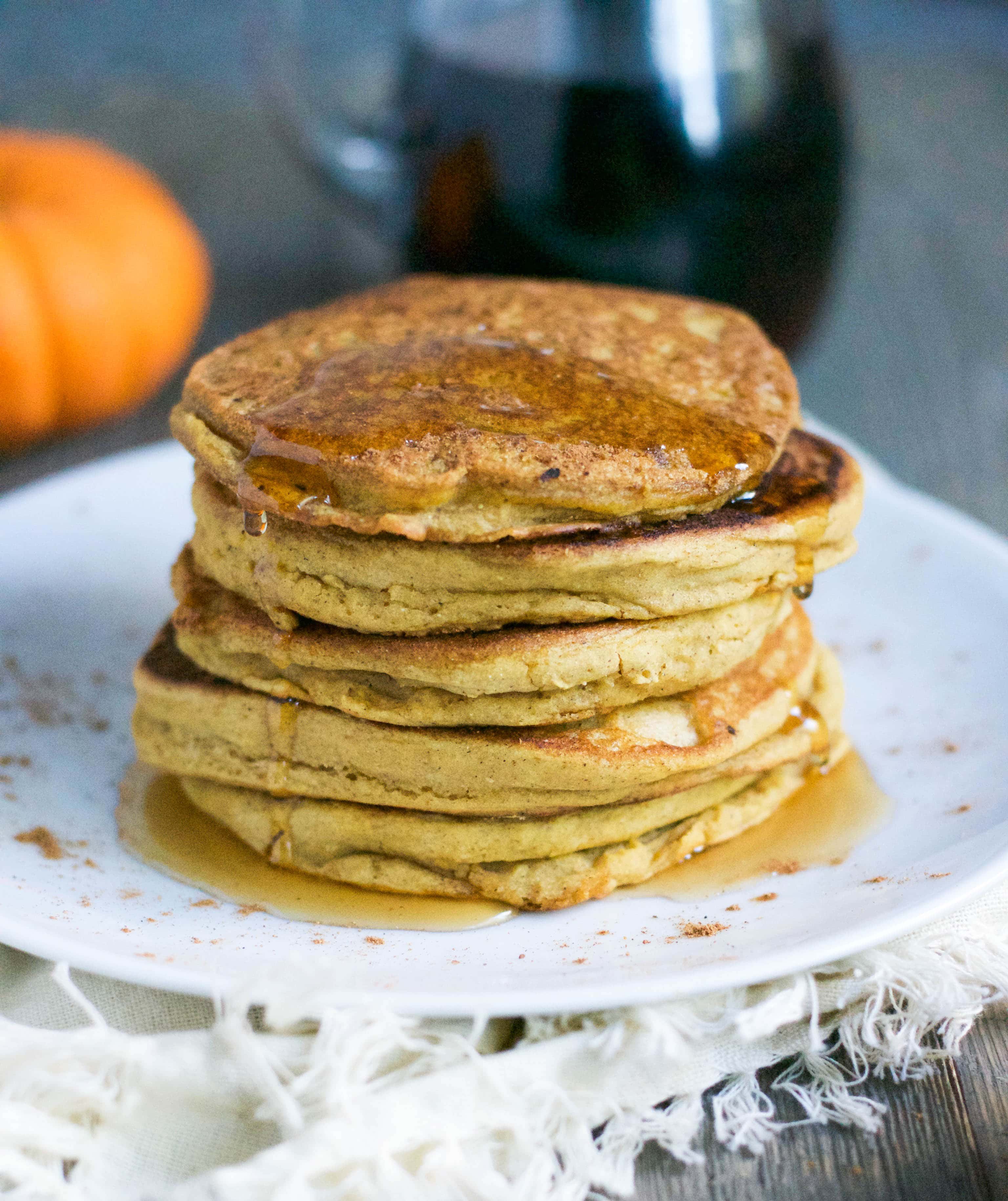 Pumpkin Spice Panckes (Vegan + GF) - you'll love how fluffy these gluten-free and vegan pumpkin spice pancakes are. Perfect for Fall! Just drizzle with some pure maple syrup or maybe some sauteed apples and vegan caramel sauce for an extra little treat! Great for weekend brunch, too! Recipe from A Dash of Megnut - see www.adashofmegnut.com