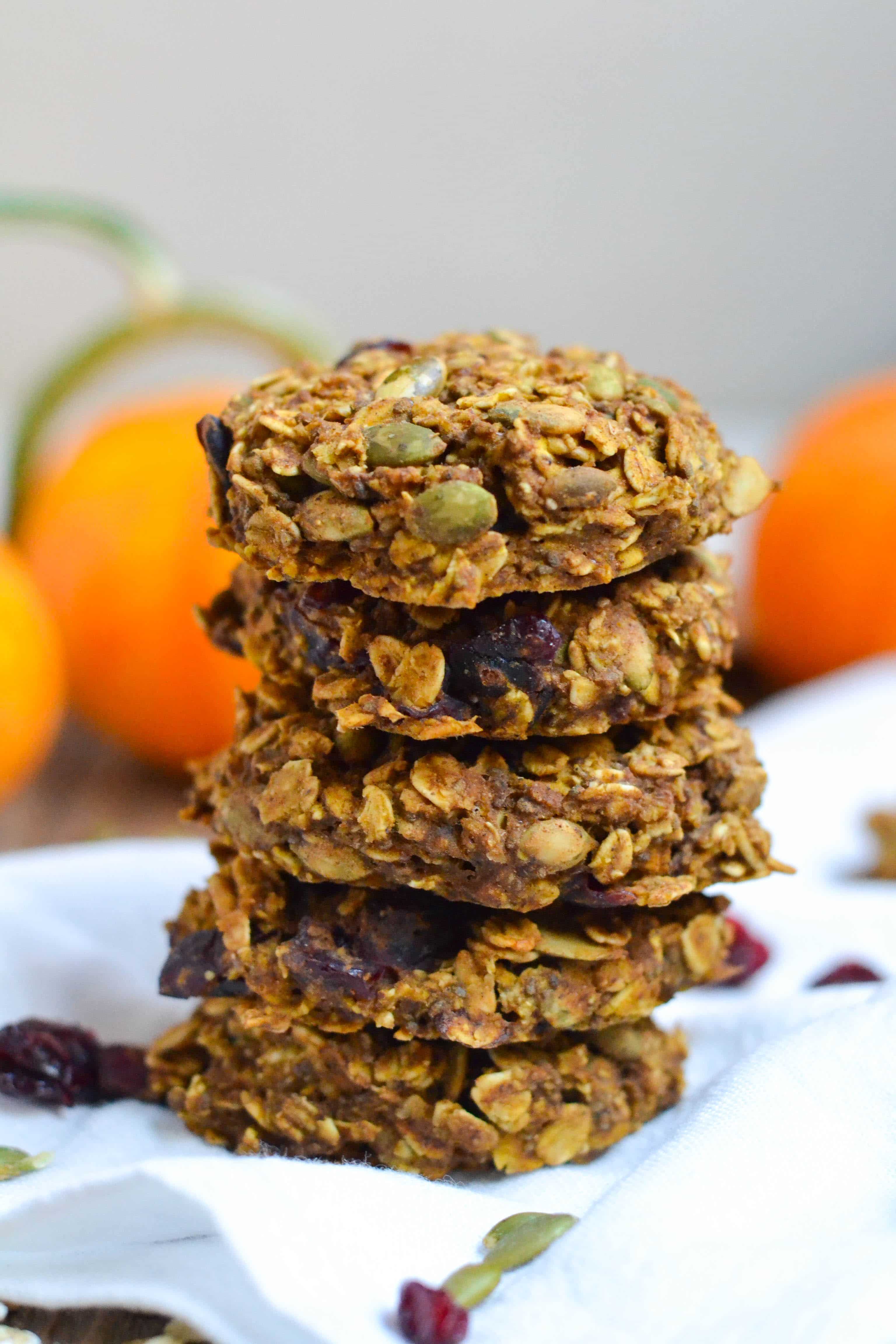 A stack of five Pumpkin Breakfast Cookies with pumpkins in the background. 