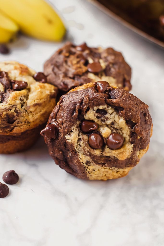 chocolate peanut butter banana with a swirl and studded with dark chocolate chips muffin in a muffin tin - gluten-free, vegan, dairy-free swirl muffin